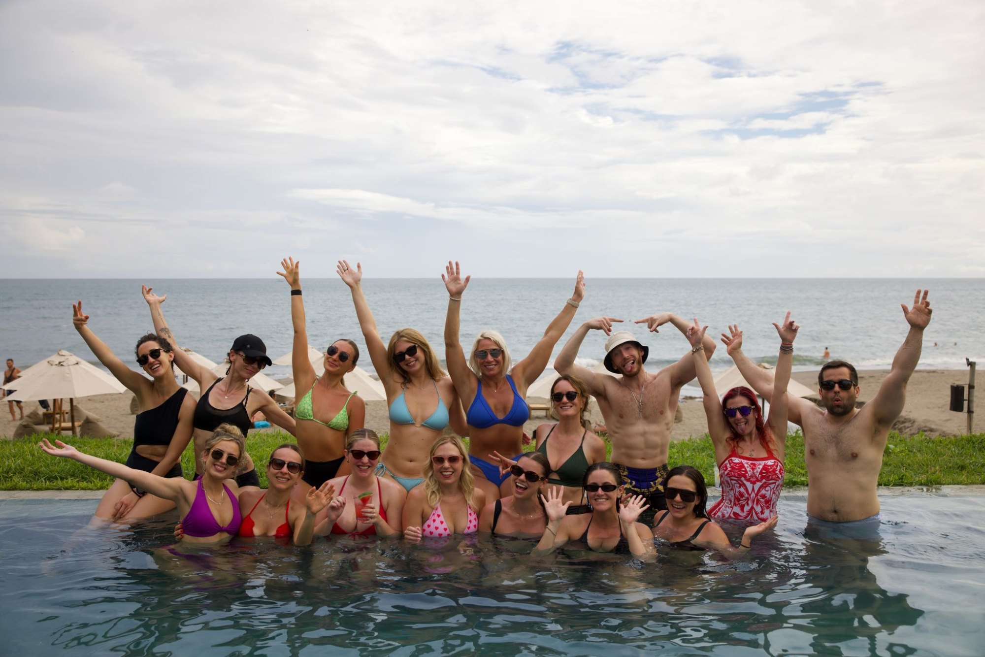 An SYB group cheering in a pool by the ocean in Bali